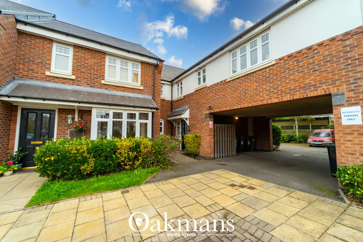 Modern brick-built residential property with driveway, parking spaces, landscaped frontage and garage entrance