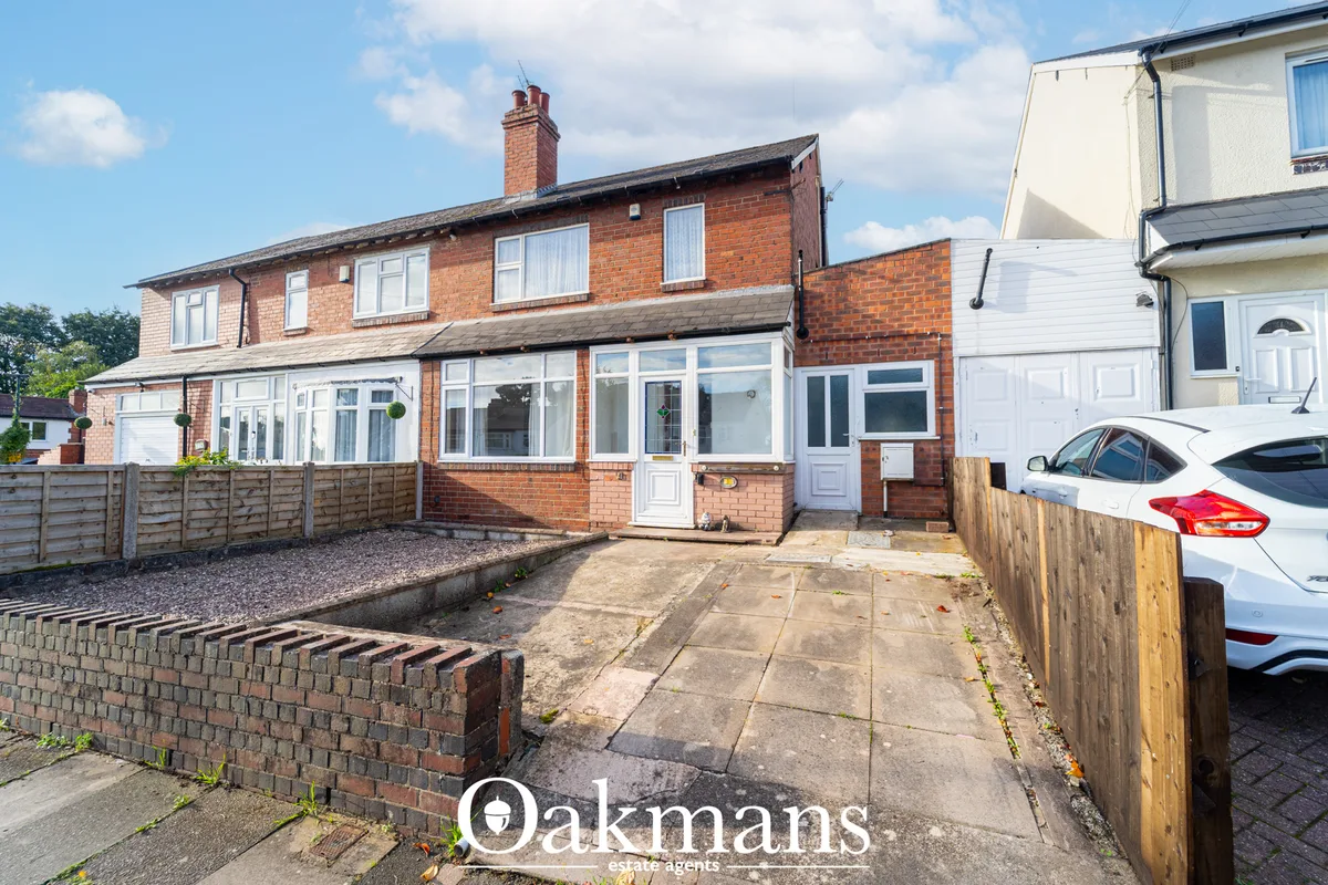 Two-storey red brick semi-detached house with white uPVC windows, white conservatory extension, brick driveway and white