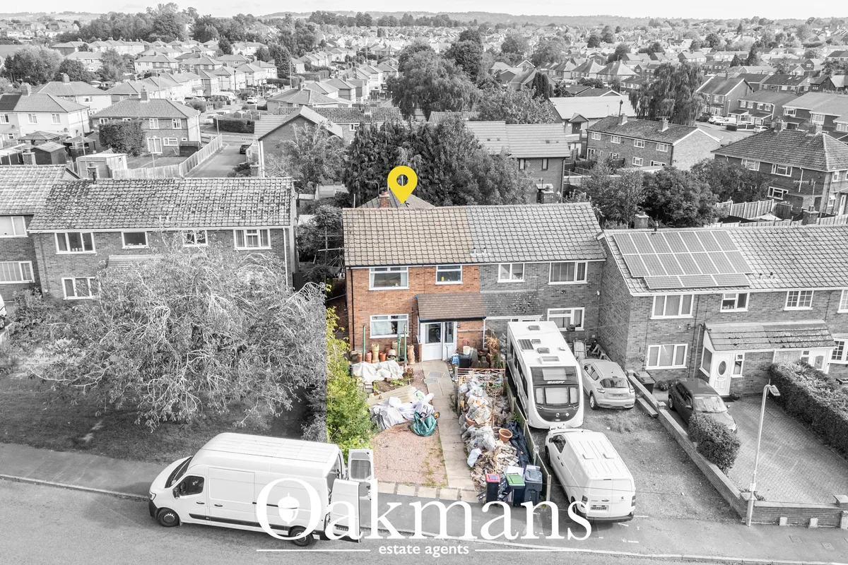 Aerial drone photograph of brick semi-detached house with yellow location pin, surrounded by residential suburban street