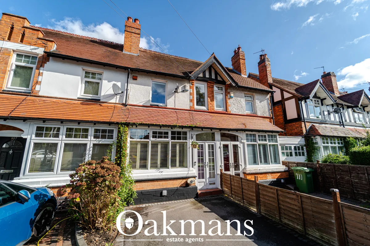 Traditional red-brick terraced house with white uPVC windows, brick chimneys, and modern ground-floor extensions. Drivew