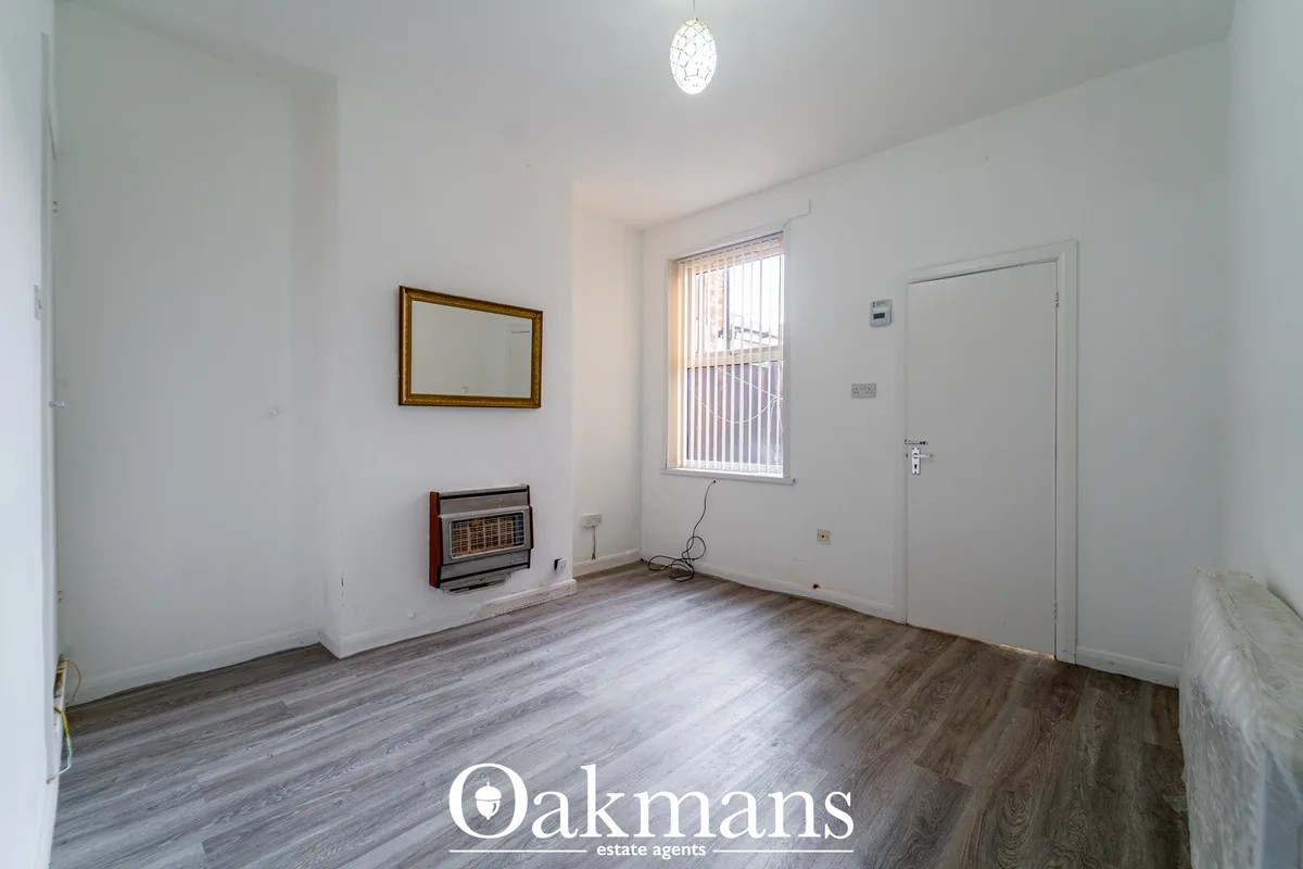 Bright hallway with wood-effect flooring, white walls, pendant light, mirror, electric heater, window with vertical blin