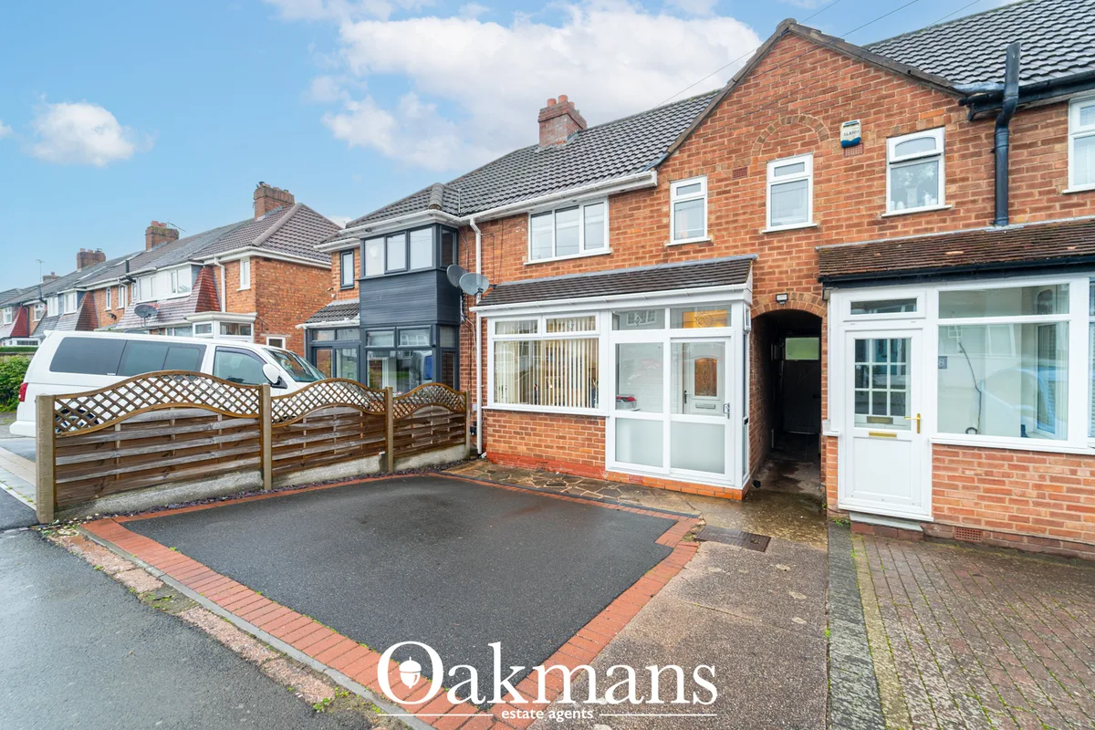 Red brick semi-detached house with white uPVC windows, modern porch extension, driveway with wooden gate and tarmac surf