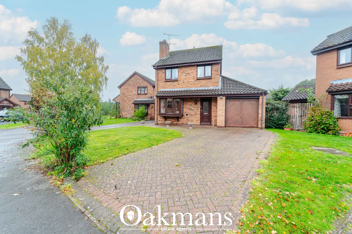 Two-storey brick detached house with driveway, brick paving, double garage, manicured lawn and landscaping